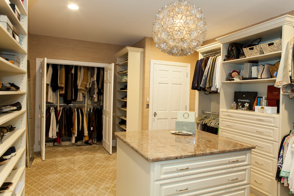 Large elegant women's carpeted dressing room photo in Philadelphia with raised-panel cabinets and white cabinets