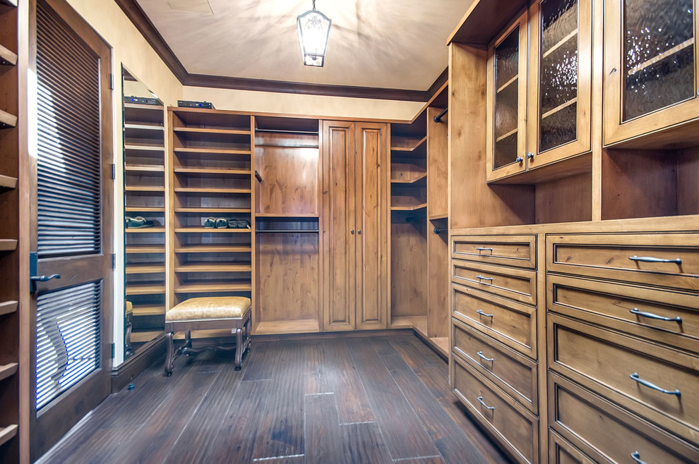 Inspiration for a large mediterranean gender-neutral dark wood floor dressing room remodel in San Francisco with beaded inset cabinets and medium tone wood cabinets