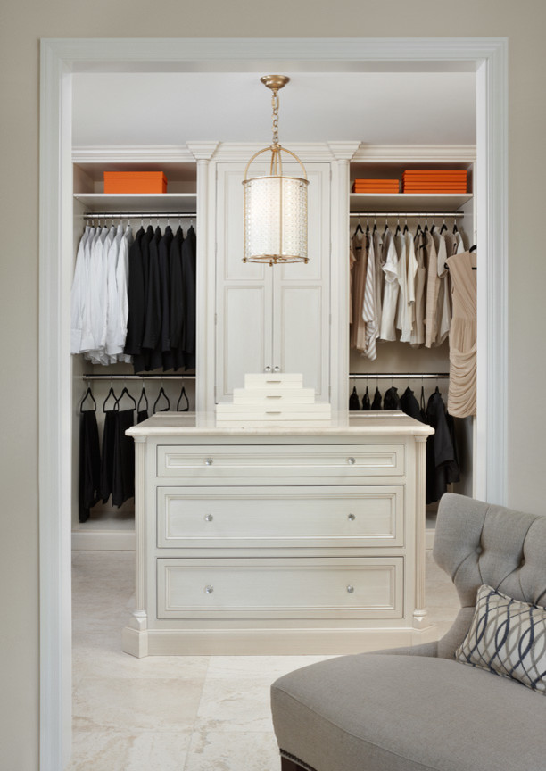 Example of a large classic gender-neutral walk-in closet design in Detroit with recessed-panel cabinets and white cabinets