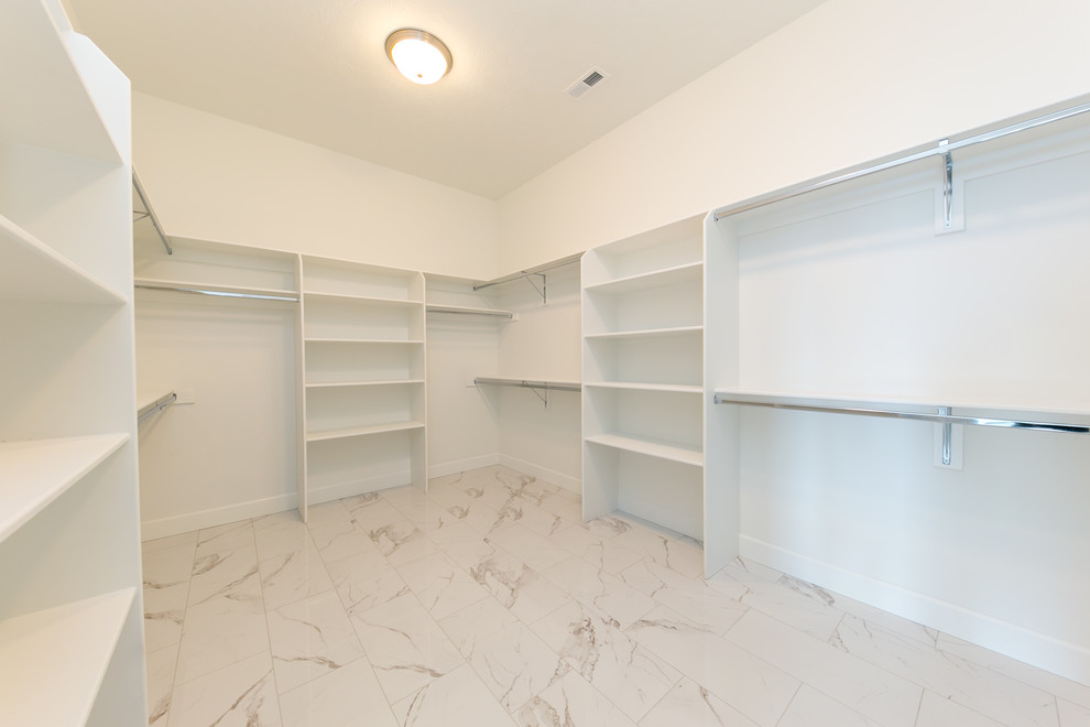 Large modern gender neutral walk-in wardrobe in Seattle with marble flooring and white floors.