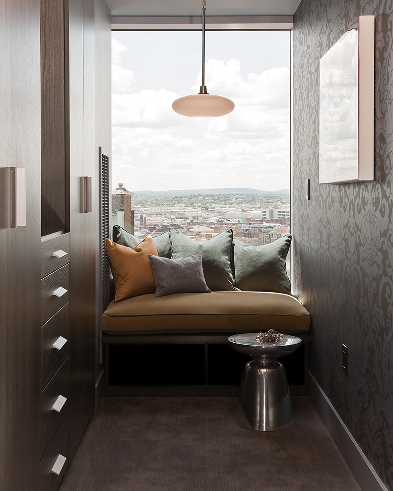 Inspiration for a mid-sized contemporary carpeted reach-in closet remodel in Boston with flat-panel cabinets and dark wood cabinets