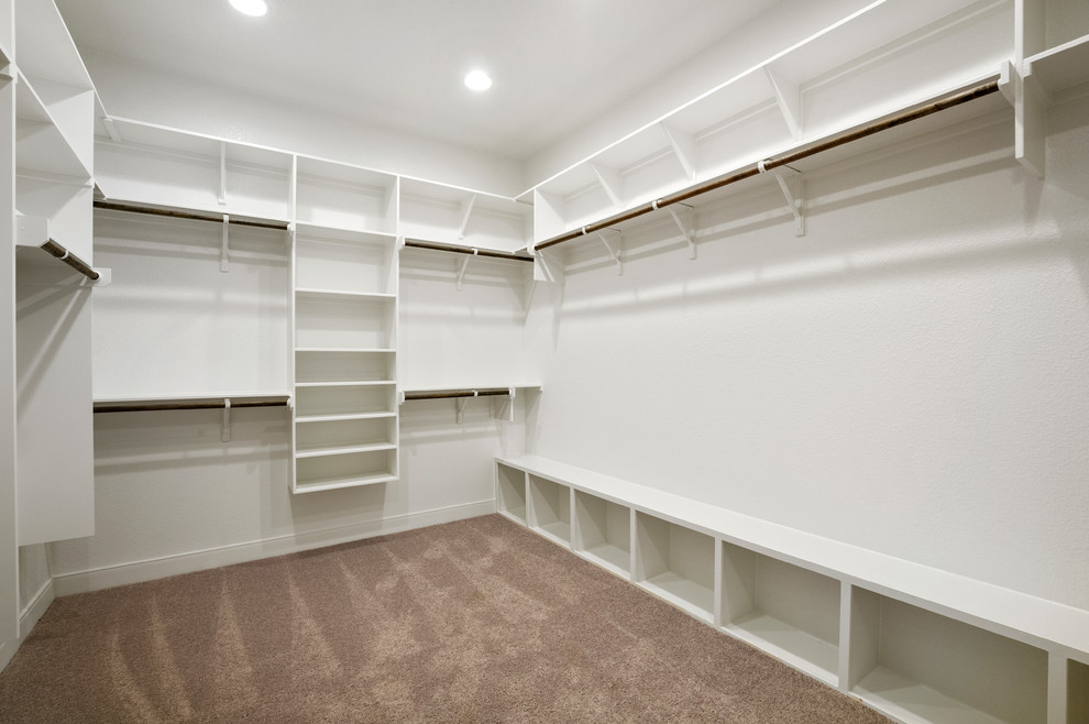 Design ideas for a large traditional gender neutral walk-in wardrobe in Austin with open cabinets, white cabinets, carpet and grey floors.