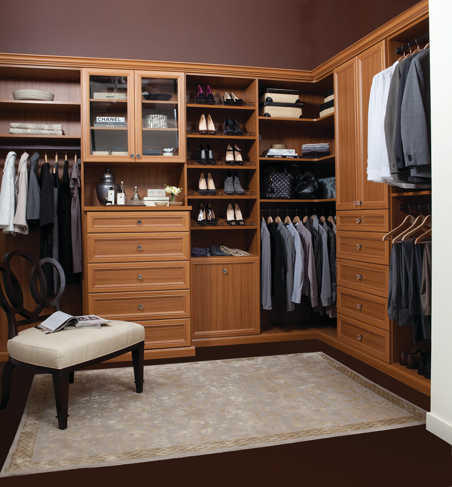 Example of a large classic gender-neutral dark wood floor and brown floor dressing room design in Orlando with open cabinets and medium tone wood cabinets