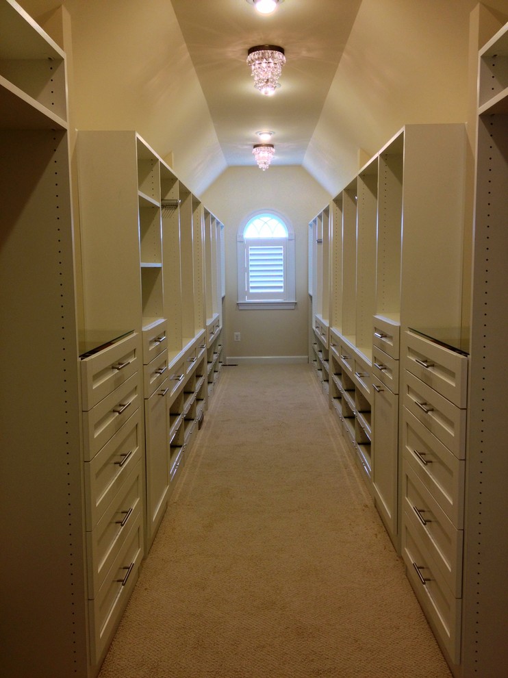 This is an example of a large contemporary gender neutral walk-in wardrobe in Philadelphia with shaker cabinets, white cabinets, carpet and brown floors.