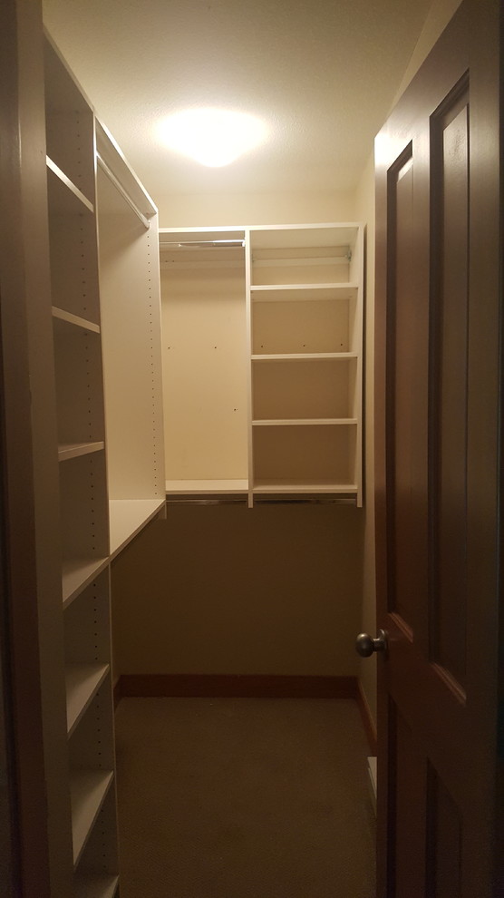 Photo of a medium sized modern gender neutral walk-in wardrobe in Vancouver with white cabinets, carpet and beige floors.