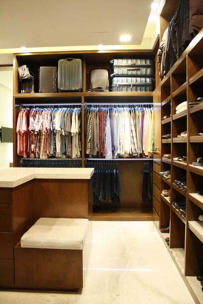 Contemporary gender neutral walk-in wardrobe in Other with flat-panel cabinets and medium wood cabinets.
