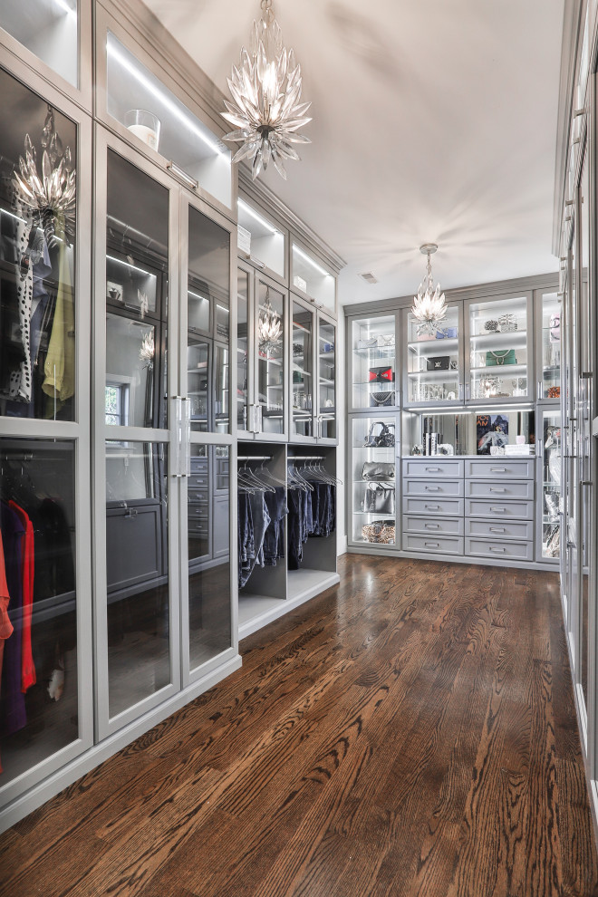 Large contemporary gender neutral walk-in wardrobe in St Louis with shaker cabinets, grey cabinets, laminate floors and brown floors.
