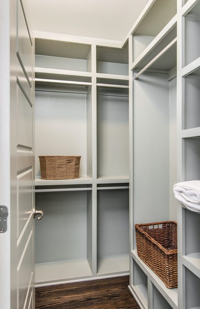 Inspiration for a small contemporary gender neutral walk-in wardrobe in Nashville with dark hardwood flooring.