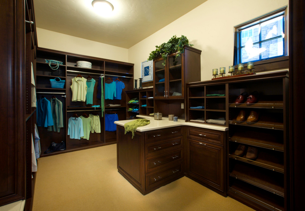 Mid-sized transitional gender-neutral walk-in closet photo in Los Angeles with dark wood cabinets and raised-panel cabinets