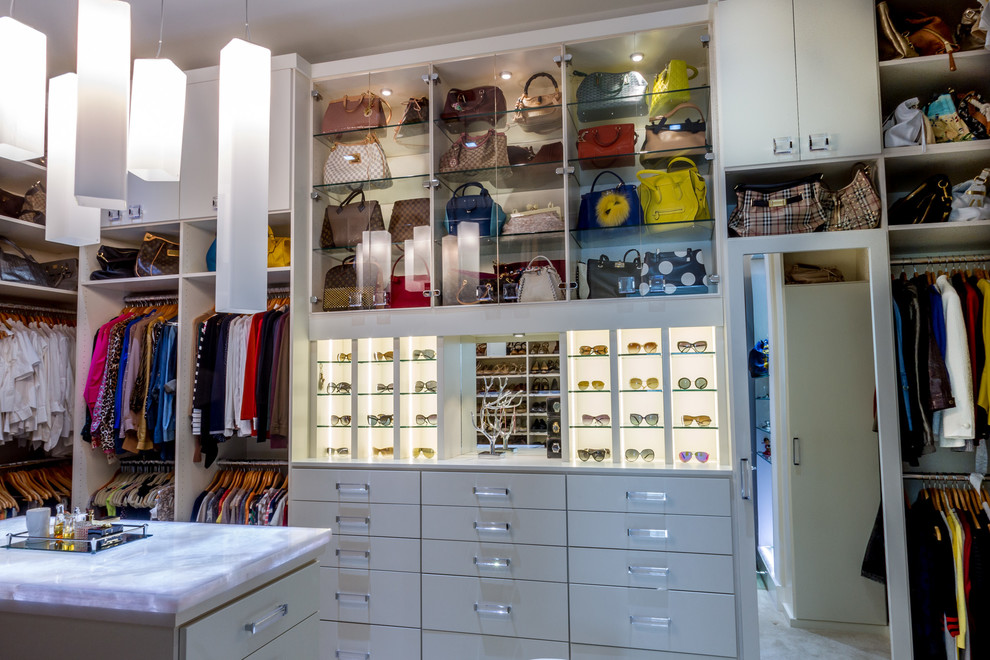 Inspiration for a transitional walk-in closet remodel in Houston with flat-panel cabinets and white cabinets