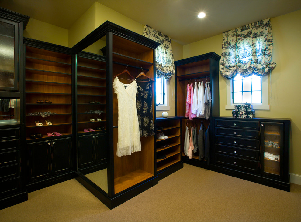 Walk-in closet - mid-sized transitional women's walk-in closet idea in Los Angeles with dark wood cabinets and recessed-panel cabinets