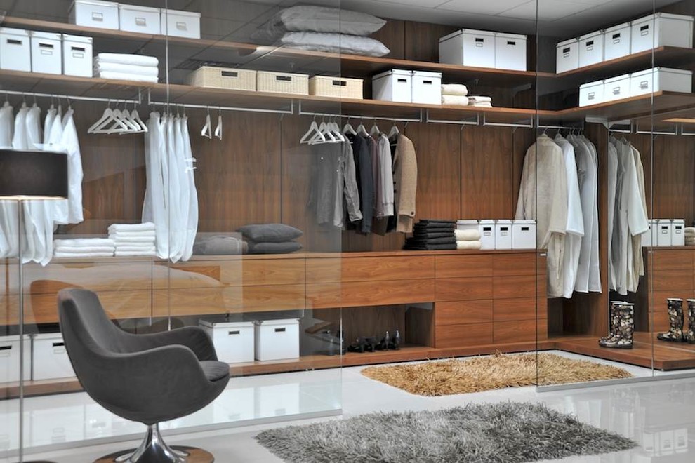 Inspiration for a large modern dressing room in New York with open cabinets and medium wood cabinets.
