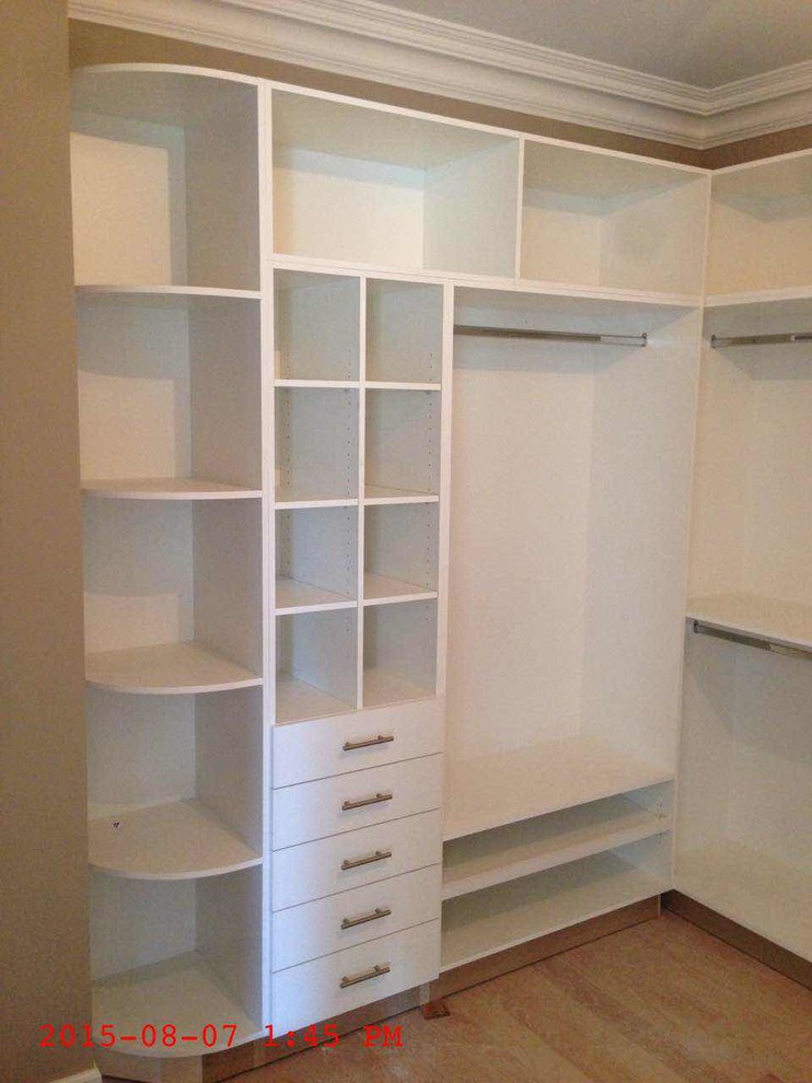 Photo of a small walk-in wardrobe for women in Toronto with flat-panel cabinets.