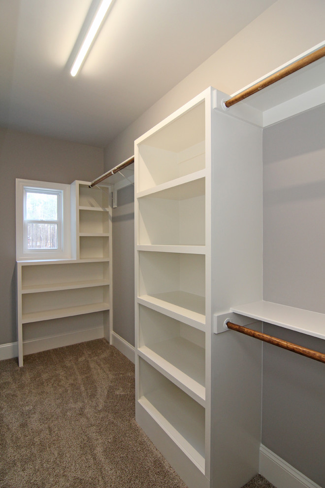 Design ideas for an expansive classic gender neutral walk-in wardrobe in Raleigh with open cabinets, white cabinets and carpet.