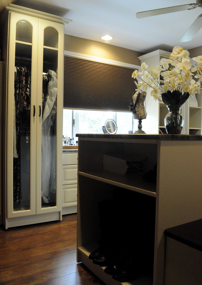 Inspiration for a large timeless women's dressing room remodel in Philadelphia with raised-panel cabinets and beige cabinets