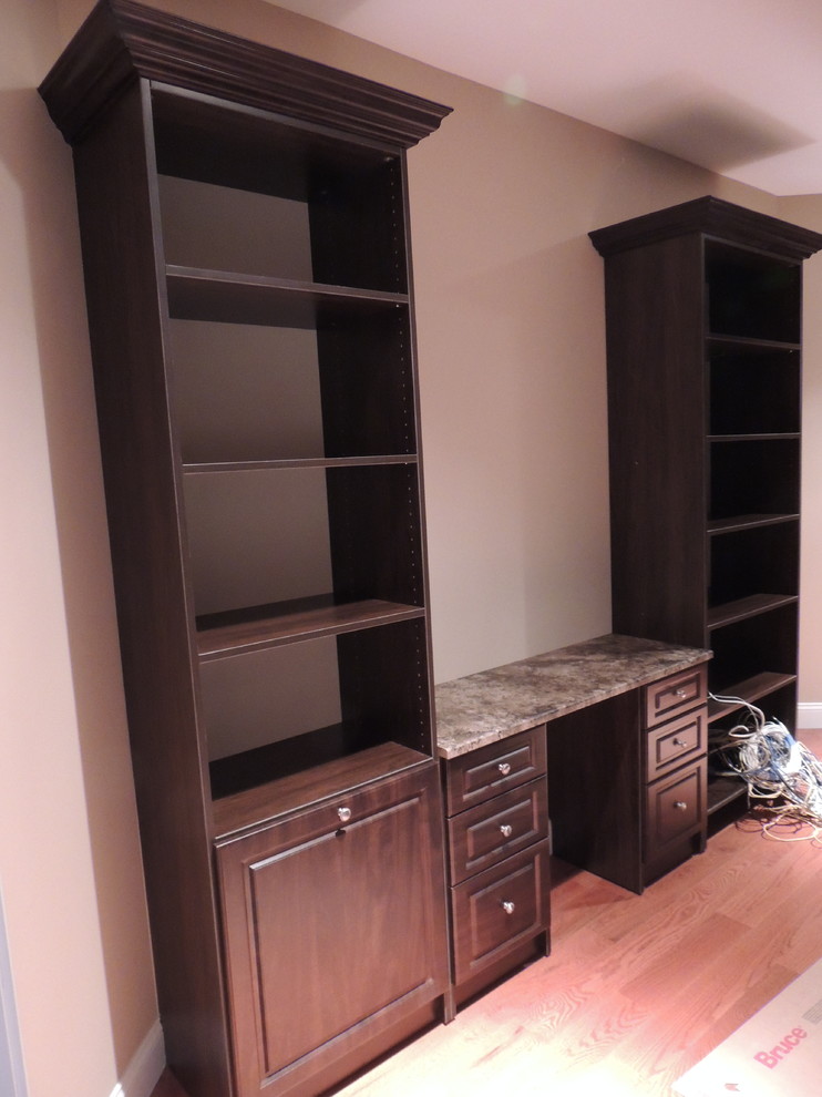Large classic gender neutral walk-in wardrobe in Philadelphia with raised-panel cabinets and brown cabinets.