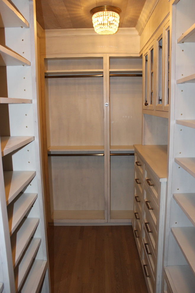 Mid-sized minimalist gender-neutral medium tone wood floor dressing room photo in New York with open cabinets and distressed cabinets