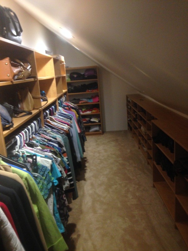 Walk-in closet - mid-sized contemporary gender-neutral carpeted walk-in closet idea in Newark with light wood cabinets