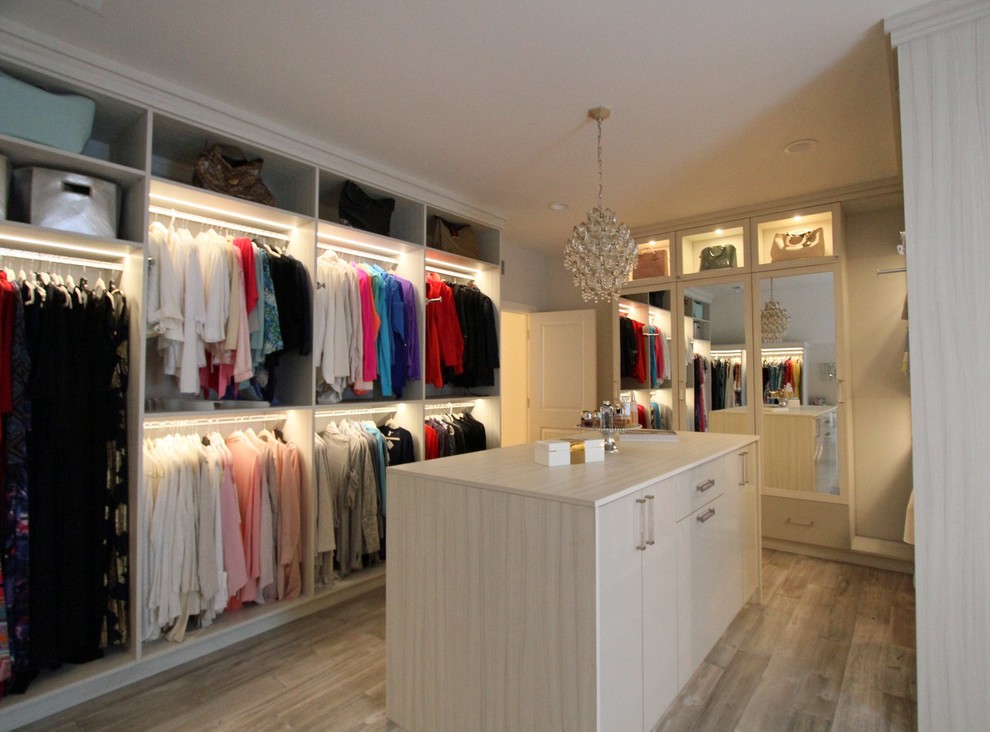 Photo of a large contemporary walk-in wardrobe in Other with flat-panel cabinets, light wood cabinets, medium hardwood flooring and brown floors.