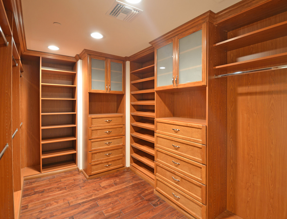 Mid-sized trendy gender-neutral light wood floor walk-in closet photo in Los Angeles with flat-panel cabinets and beige cabinets