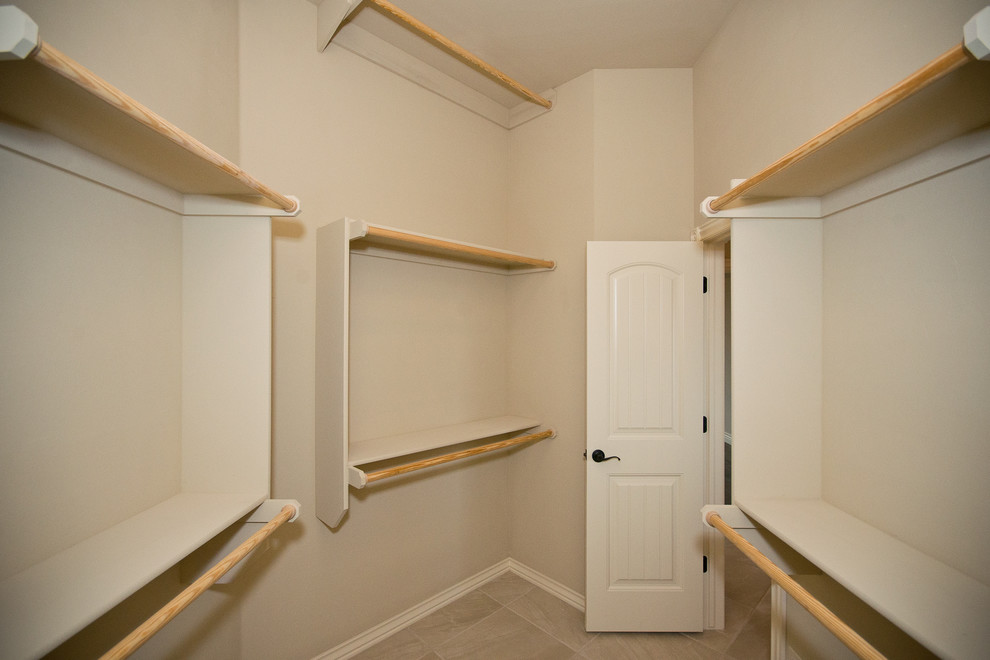 Medium sized traditional gender neutral walk-in wardrobe in Oklahoma City with open cabinets, beige cabinets and ceramic flooring.