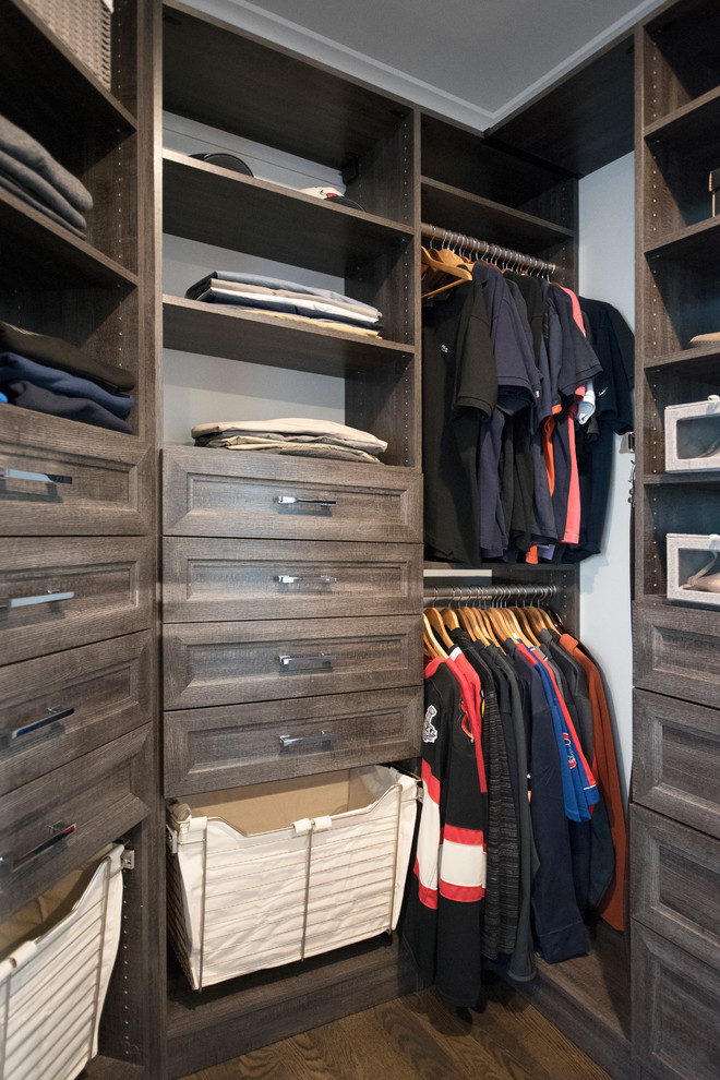 Walk-in closet - mid-sized transitional gender-neutral dark wood floor and brown floor walk-in closet idea in Chicago with recessed-panel cabinets and distressed cabinets