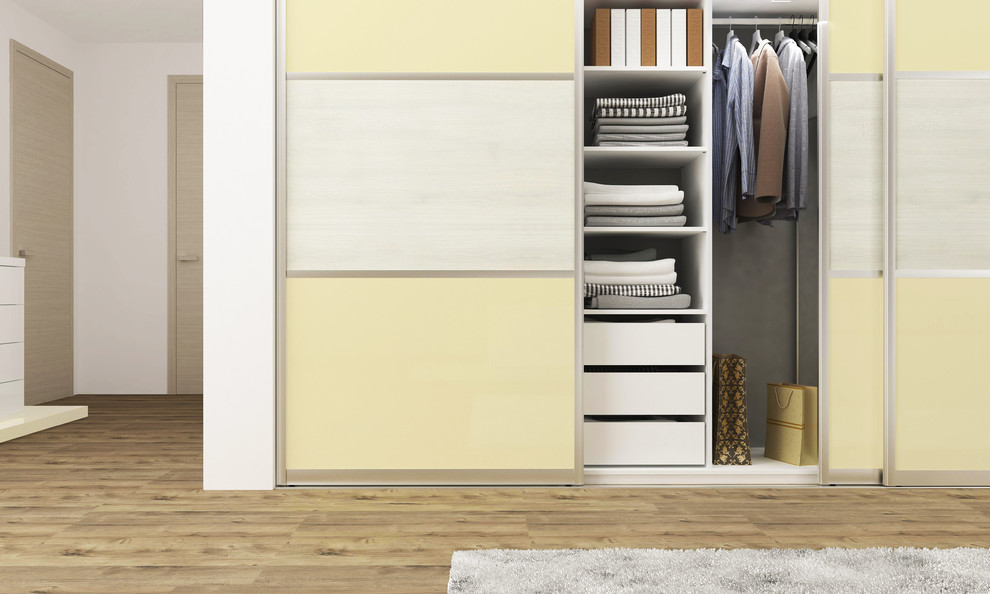 Example of a mid-sized minimalist reach-in closet design in New York with flat-panel cabinets and yellow cabinets
