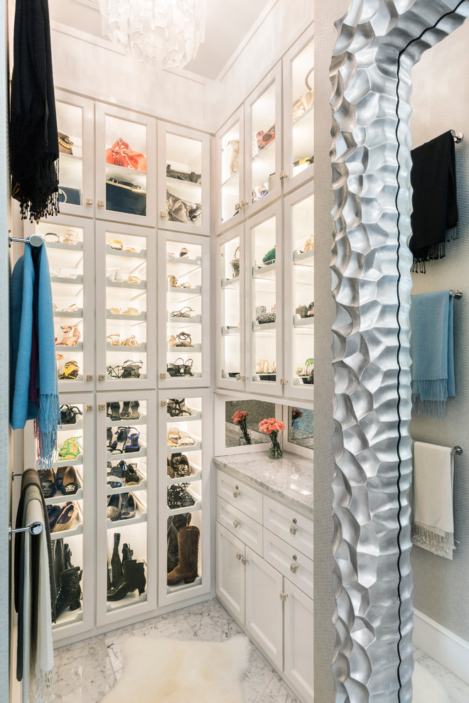 Photo of a contemporary dressing room for women in Houston with glass-front cabinets, white cabinets and porcelain flooring.