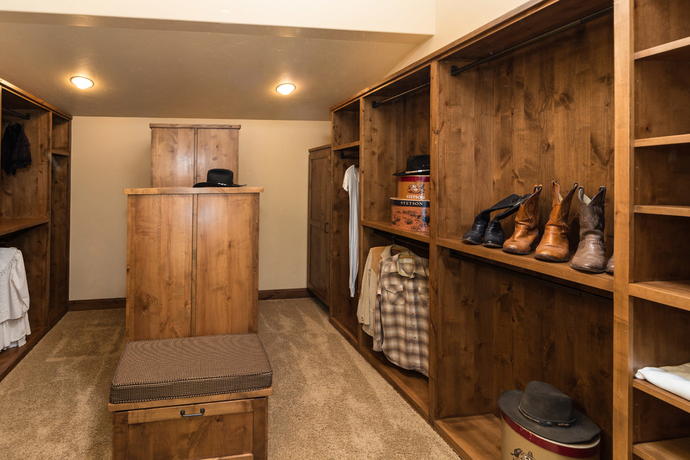 Inspiration for a large rustic carpeted closet remodel in Other