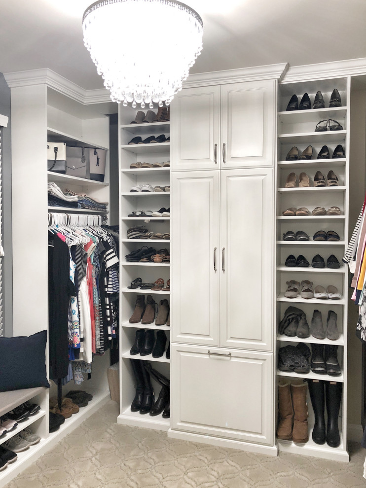Large traditional walk-in wardrobe in St Louis with raised-panel cabinets, white cabinets, carpet and beige floors.