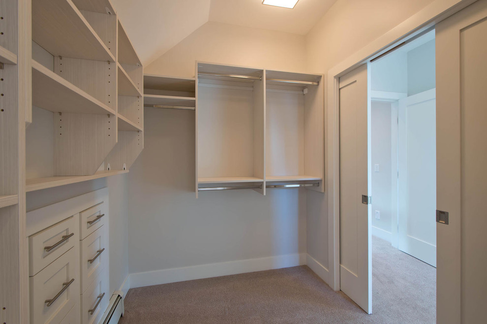 Inspiration for a medium sized contemporary gender neutral walk-in wardrobe in Vancouver with shaker cabinets, white cabinets and carpet.