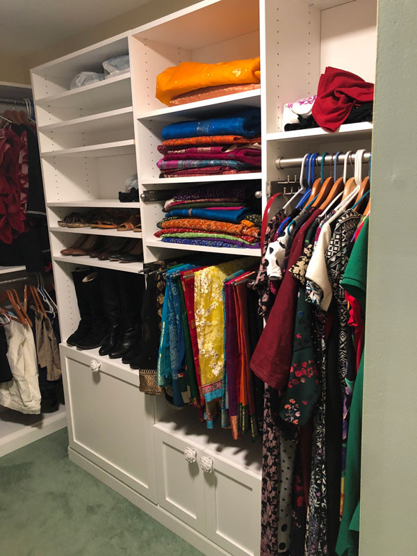 This is an example of a medium sized classic dressing room for women in Other with shaker cabinets, white cabinets, carpet and green floors.