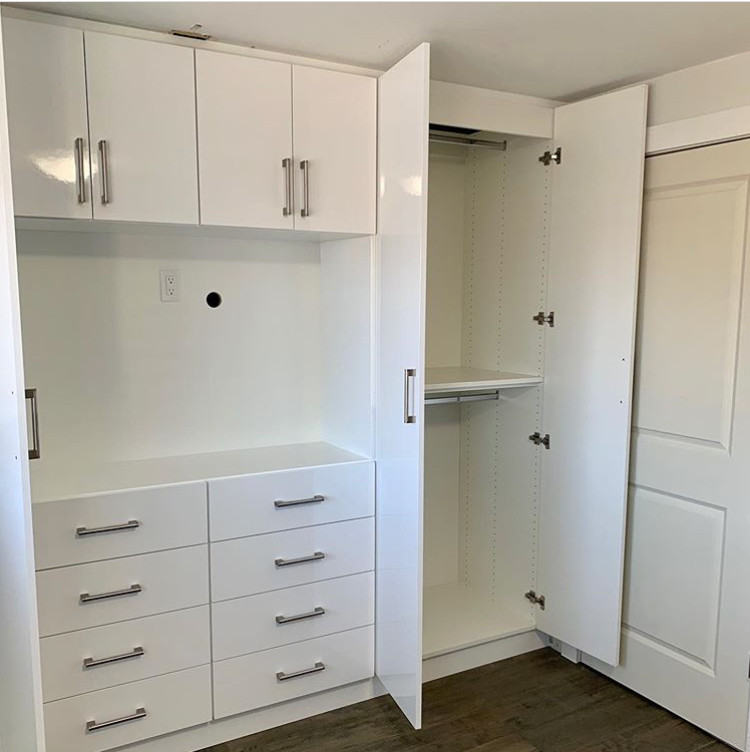 Cette photo montre une armoire encastrée neutre avec un placard à porte plane et des portes de placard blanches.