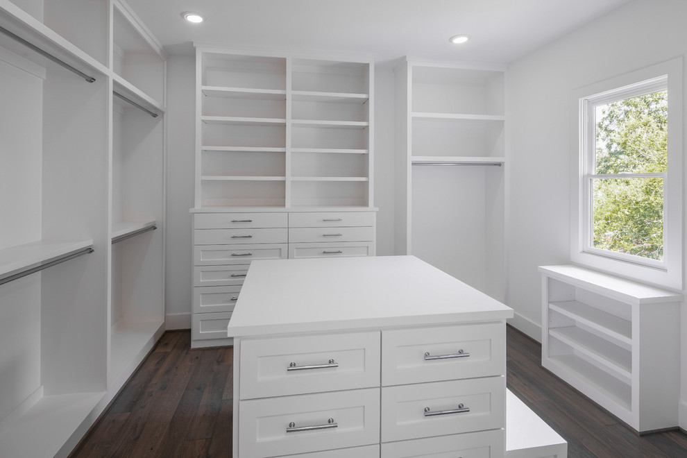 Inspiration for a large classic gender neutral walk-in wardrobe in Houston with shaker cabinets, white cabinets, dark hardwood flooring and brown floors.