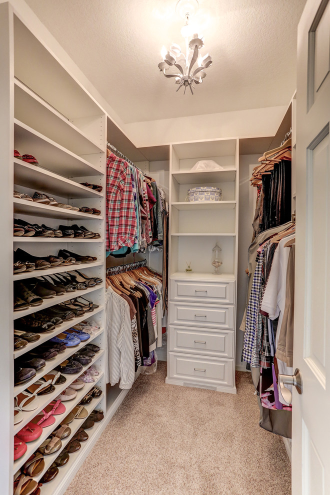 Inspiration for a medium sized traditional gender neutral walk-in wardrobe in Minneapolis with white cabinets, carpet and beige floors.