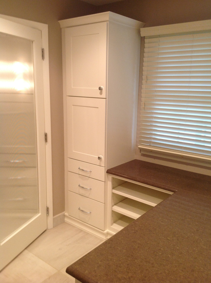Example of a transitional porcelain tile walk-in closet design in Wichita with flat-panel cabinets and white cabinets
