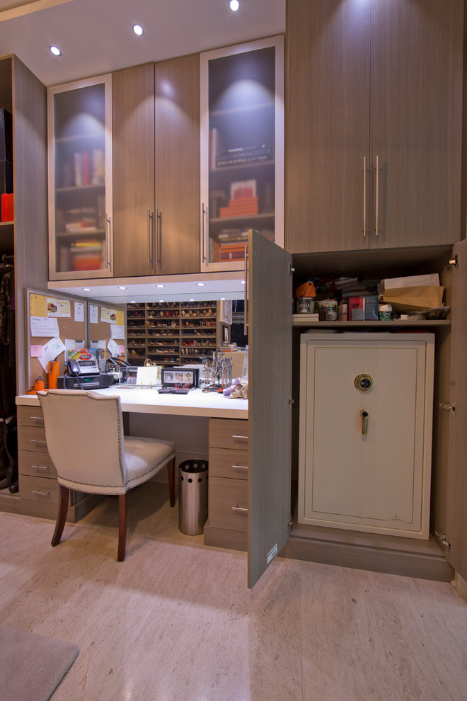 Example of a huge minimalist women's travertine floor dressing room design in New Orleans with flat-panel cabinets and gray cabinets