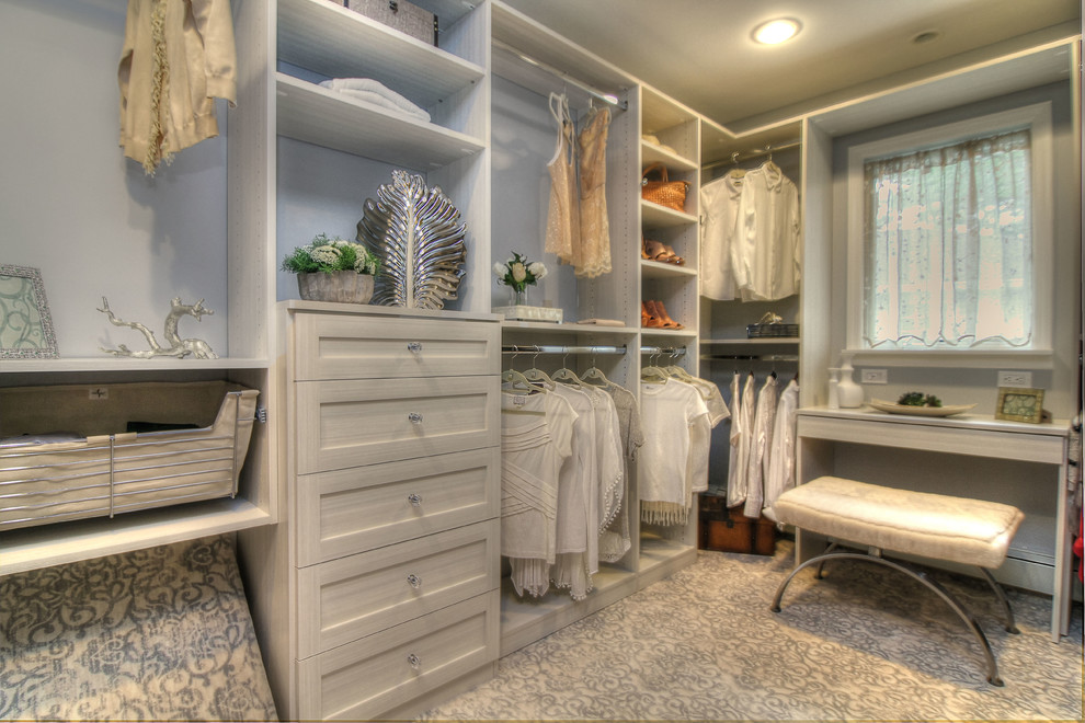 Design ideas for a medium sized classic walk-in wardrobe for women in New York with carpet, multi-coloured floors, grey cabinets and recessed-panel cabinets.