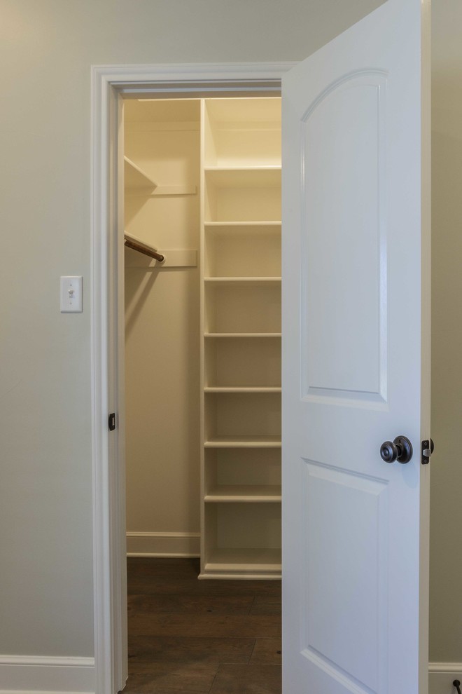 Example of a large transitional gender-neutral porcelain tile walk-in closet design in Austin with open cabinets and white cabinets