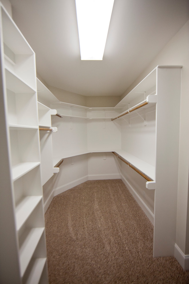 Inspiration for a large gender neutral walk-in wardrobe in Raleigh with white cabinets.