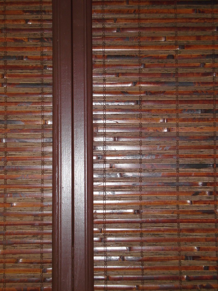 Example of a mid-sized zen gender-neutral bamboo floor reach-in closet design in Orange County with medium tone wood cabinets and recessed-panel cabinets