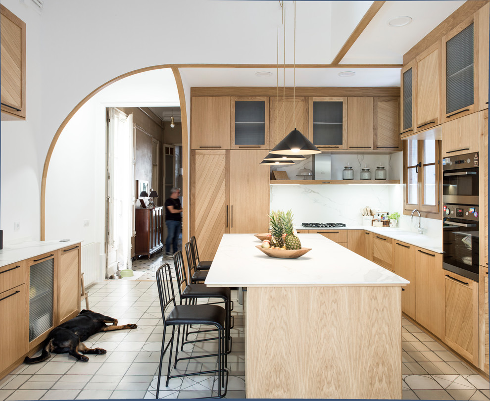Klassisk inredning av ett stort kök, med en undermonterad diskho, luckor med upphöjd panel, skåp i mellenmörkt trä, marmorbänkskiva, vitt stänkskydd, stänkskydd i marmor, rostfria vitvaror, klinkergolv i keramik, en köksö och flerfärgat golv