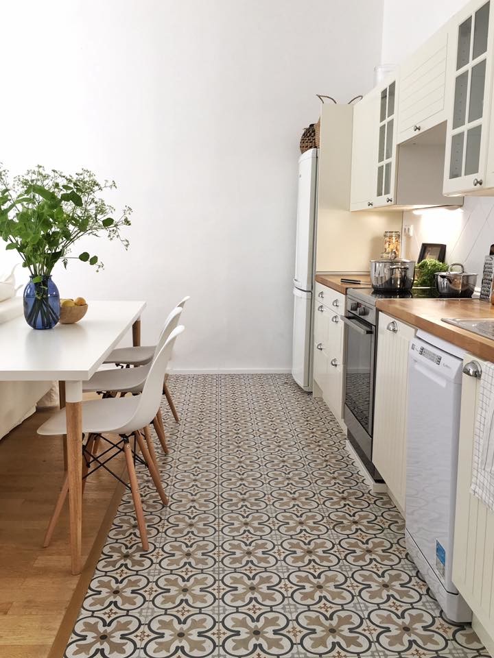 Inspiration for a small transitional single-wall ceramic tile and multicolored floor open concept kitchen remodel in Barcelona with a double-bowl sink, glass-front cabinets, white cabinets, wood countertops, white backsplash, ceramic backsplash, stainless steel appliances and no island