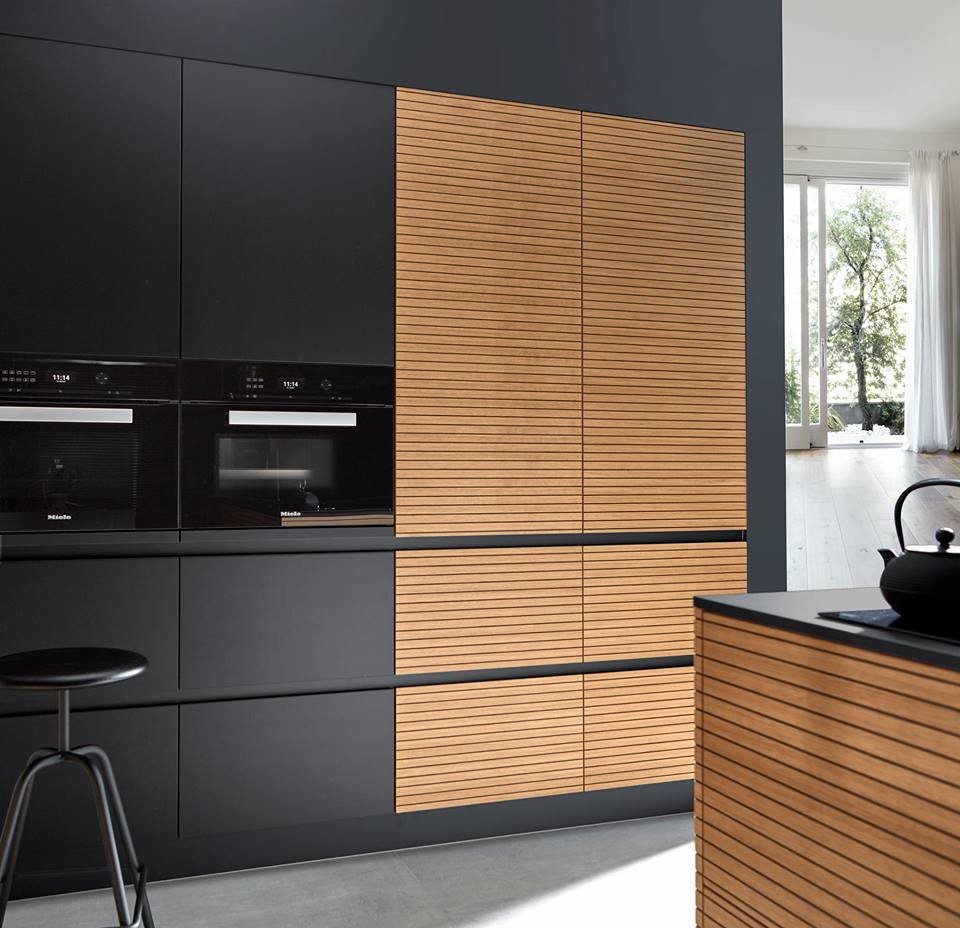 Design ideas for an expansive urban u-shaped open plan kitchen in Other with light wood cabinets, black appliances, ceramic flooring, an island, grey floors and black worktops.
