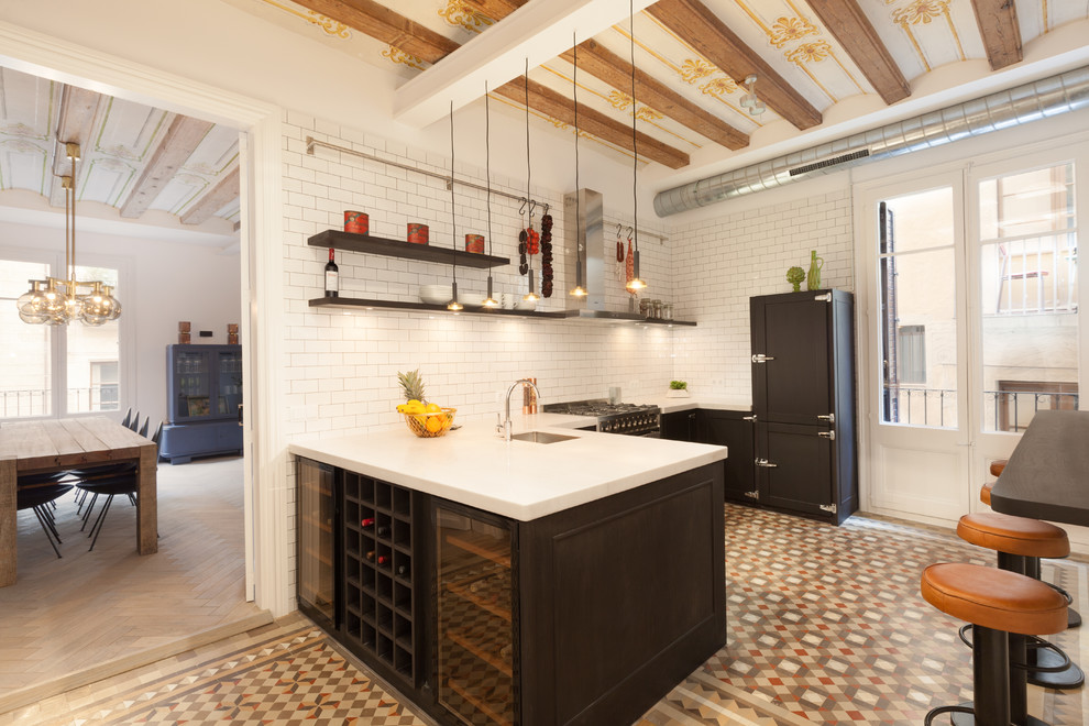 Photo of a medium sized scandi u-shaped enclosed kitchen in Barcelona with a submerged sink, black cabinets, white splashback, integrated appliances, ceramic flooring, a breakfast bar, open cabinets and metro tiled splashback.