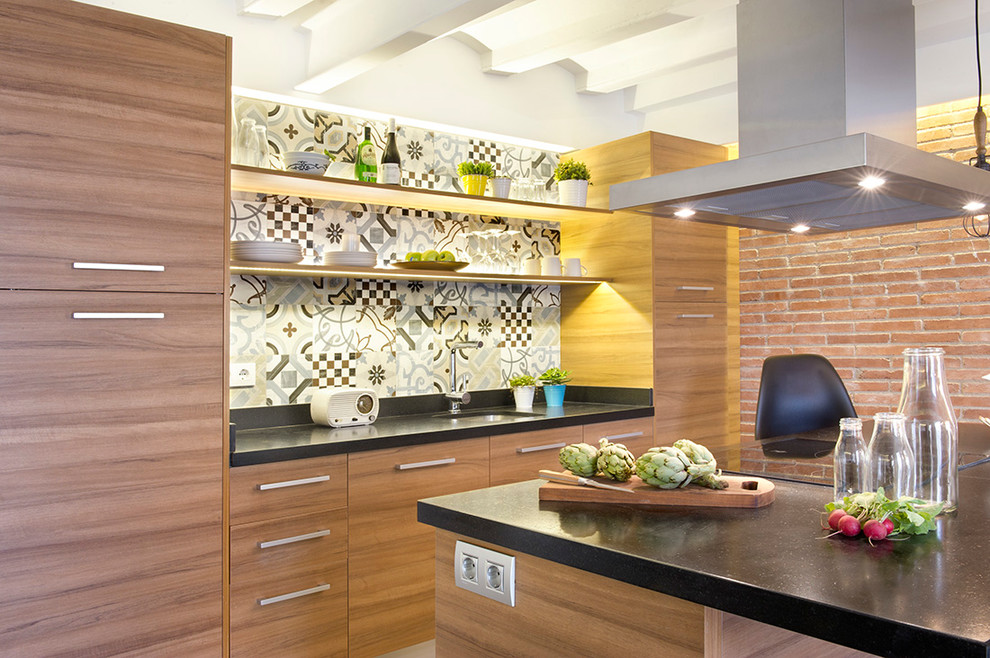 Open concept kitchen - mid-sized contemporary galley open concept kitchen idea in Madrid with flat-panel cabinets, medium tone wood cabinets, solid surface countertops, multicolored backsplash, ceramic backsplash and an island