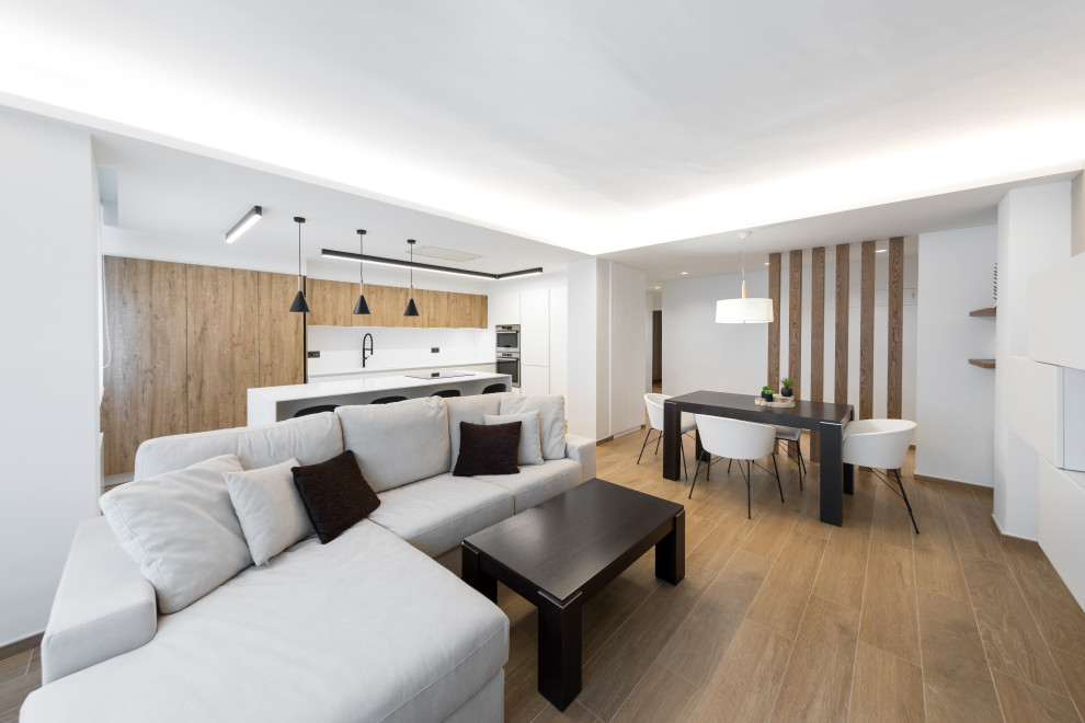 Photo of a medium sized contemporary kitchen in Other with flat-panel cabinets, white cabinets, porcelain flooring and an island.