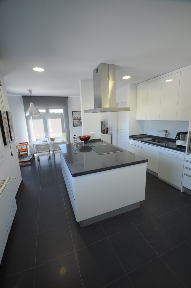 Design ideas for a medium sized contemporary l-shaped kitchen/diner in Other with a built-in sink, flat-panel cabinets, white cabinets, engineered stone countertops, white splashback, ceramic splashback, white appliances, ceramic flooring and an island.
