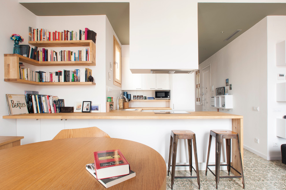 Design ideas for a medium sized scandinavian u-shaped open plan kitchen in Barcelona with flat-panel cabinets, white cabinets, wood worktops, ceramic flooring and no island.