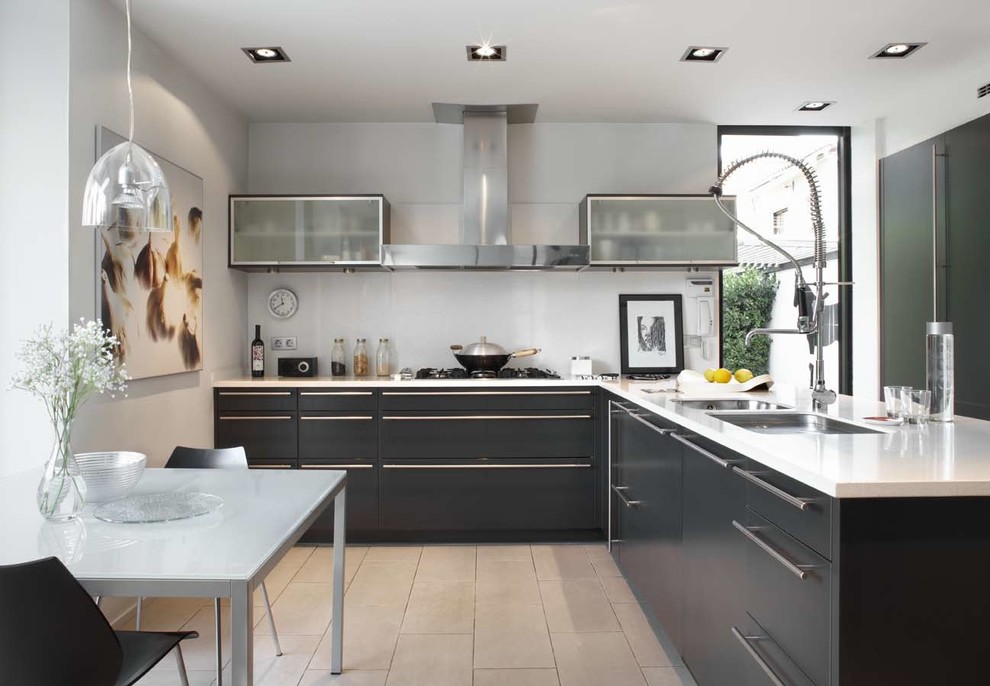 Medium sized bohemian l-shaped kitchen/diner in Barcelona with a double-bowl sink, flat-panel cabinets, black cabinets, composite countertops, white splashback, stainless steel appliances, ceramic flooring and no island.